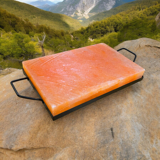 "Grill-ready Himalayan salt block resting on a natural rock base."