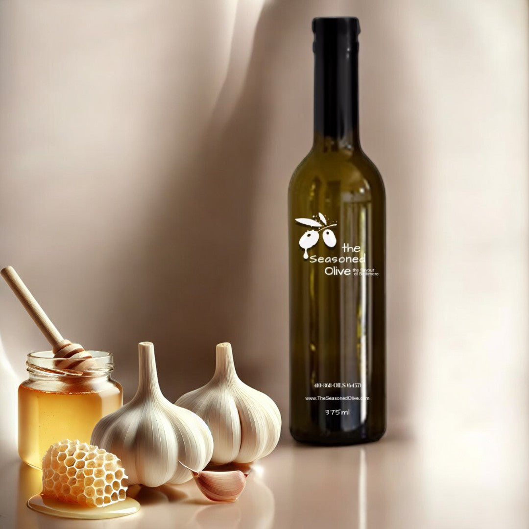 Elegant ivory cream background featuring whole garlic cloves and a honey drizzle, creating a fresh, refined display that highlights the savory-sweet essence of Honey Garlic White Balsamic Vinegar.