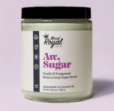 Thrilla in Vanilla Sugar Scrub in a luxurious jar, surrounded by natural ingredients for soft, glowing skin.